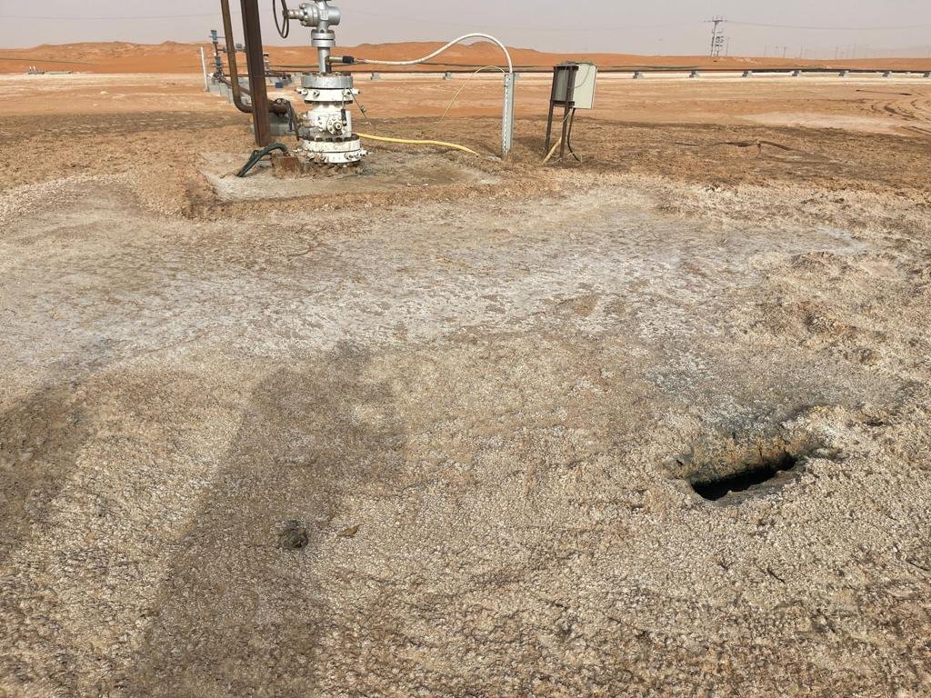 Gas venting crater next to a wellhead